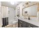 Updated bathroom features a vanity with granite counter, framed mirror and tub with shower at 4023 Anvil Block Rd, Ellenwood, GA 30294