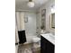 Modern bathroom with white subway tile, a tub, and a black vanity at 4023 Anvil Block Rd, Ellenwood, GA 30294