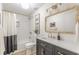 Well-lit bathroom with a shower-tub combo, dark vanity with gold hardware, and modern fixtures at 4023 Anvil Block Rd, Ellenwood, GA 30294