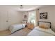 Bedroom featuring two beds with neutral colors and view from the window at 4023 Anvil Block Rd, Ellenwood, GA 30294