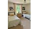 Shared bedroom featuring twin beds with gingham bedding, soft carpet, and warm natural lighting at 4023 Anvil Block Rd, Ellenwood, GA 30294