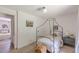 Bedroom featuring neutral colors, decorative canopy bed, and view to the connecting bedroom at 4023 Anvil Block Rd, Ellenwood, GA 30294