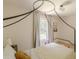 Neutral bedroom with unique black canopy bed frame, decor and natural light at 4023 Anvil Block Rd, Ellenwood, GA 30294