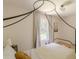 Bedroom featuring a decorative canopy bed, neutral color scheme, and natural light from the window at 4023 Anvil Block Rd, Ellenwood, GA 30294