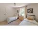 Charming bedroom featuring twin beds with checkered bedding, neutral walls and natural light at 4023 Anvil Block Rd, Ellenwood, GA 30294