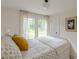 Bright bedroom with a queen-sized bed, natural light, and neutral decor at 4023 Anvil Block Rd, Ellenwood, GA 30294