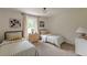 Bedroom featuring two beds with neutral colors and view from the window with white trim at 4023 Anvil Block Rd, Ellenwood, GA 30294