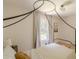 Neutral bedroom with unique black canopy bed frame, decor and natural light at 4023 Anvil Block Rd, Ellenwood, GA 30294