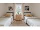 Bright bedroom featuring twin beds with checkered bedding, decor and natural light at 4023 Anvil Block Rd, Ellenwood, GA 30294