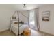 Neutral bedroom with unique black canopy bed frame, decor and natural light at 4023 Anvil Block Rd, Ellenwood, GA 30294