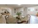 Spacious dining room with a large table, living room access, and neutral decor at 4023 Anvil Block Rd, Ellenwood, GA 30294