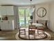 Dining area featuring a modern chandelier and access to an outdoor seating area at 4023 Anvil Block Rd, Ellenwood, GA 30294