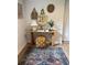 Cozy entryway featuring a wooden console table, decorative rug, and stylish wall decor at 4023 Anvil Block Rd, Ellenwood, GA 30294
