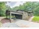 Home exterior with a carport, deck, well-manicured landscaping and a paved driveway at 4023 Anvil Block Rd, Ellenwood, GA 30294