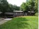 Charming home featuring a lush lawn and carport at 4023 Anvil Block Rd, Ellenwood, GA 30294