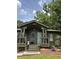 Inviting front porch with exterior light fixture and lush landscape at 4023 Anvil Block Rd, Ellenwood, GA 30294