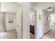 Hallway view showcasing connecting rooms and bathroom featuring a dark vanity at 4023 Anvil Block Rd, Ellenwood, GA 30294