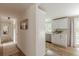 Hallway leading to a modern kitchen with a farmhouse sink and white cabinetry, with views to the deck at 4023 Anvil Block Rd, Ellenwood, GA 30294