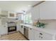 Bright kitchen featuring white cabinets, stone backsplash, and stainless appliances at 4023 Anvil Block Rd, Ellenwood, GA 30294