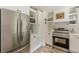 Bright kitchen features stainless steel appliances, light wood floors, and white cabinets at 4023 Anvil Block Rd, Ellenwood, GA 30294