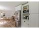 Kitchen view showcasing stainless steel refrigerator, microwave, white cabinets, and eat-in dining space at 4023 Anvil Block Rd, Ellenwood, GA 30294