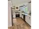 Bright kitchen featuring white cabinets, stainless steel appliances, and a farmhouse sink beneath a window at 4023 Anvil Block Rd, Ellenwood, GA 30294