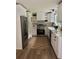 Bright kitchen with stainless steel appliances and white cabinets at 4023 Anvil Block Rd, Ellenwood, GA 30294