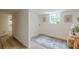 Well-lit laundry room with natural light, decorative artwork, and a patterned rug at 4023 Anvil Block Rd, Ellenwood, GA 30294