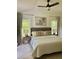 Calming primary bedroom featuring nature views and ceiling fan at 4023 Anvil Block Rd, Ellenwood, GA 30294