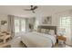 Bright main bedroom with multiple windows letting in natural light, ceiling fan, and neutral color scheme at 4023 Anvil Block Rd, Ellenwood, GA 30294