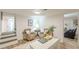 Well-lit home office space with a desk, comfortable chairs, and adjacent staircase at 4023 Anvil Block Rd, Ellenwood, GA 30294