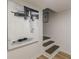 Basement steps with an art display on the wall and light wood floors at 4023 Anvil Block Rd, Ellenwood, GA 30294