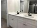 Bathroom featuring double sinks, modern white cabinets, and a large mirror at 5463 Blossomwood Sw Trl, Mableton, GA 30126