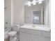 A white bathroom featuring an integrated sink and cabinet, toilet, and tub with shower at 10775 Brunson Dr, Johns Creek, GA 30097