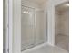 The modern bathroom features a large glass enclosed shower and neutral color palette at 10775 Brunson Dr, Johns Creek, GA 30097