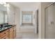 This bathroom is bright and features a soaking tub and a glass enclosed shower at 10775 Brunson Dr, Johns Creek, GA 30097