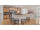 Open kitchen featuring a breakfast bar, stainless steel appliances, and wooden cabinets at 10775 Brunson Dr, Johns Creek, GA 30097