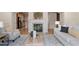 Spacious living room with a fireplace, natural light and hardwood floors at 10775 Brunson Dr, Johns Creek, GA 30097