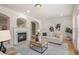 Bright living room featuring a fireplace and natural light at 10775 Brunson Dr, Johns Creek, GA 30097