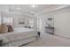 This primary bedroom provides great light, a tray ceiling, and is carpeted at 10775 Brunson Dr, Johns Creek, GA 30097
