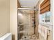 Tiled bathroom shower with sliding glass door and built-in shelving for toiletries at 1209 Colony Cir, Marietta, GA 30068