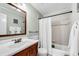 Bathroom with tub and shower combination, featuring a white shower curtain and vanity sink at 1209 Colony Cir, Marietta, GA 30068