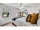 This bedroom is illuminated by natural light, complemented by neutral decor and hardwood furnishings at 1209 Colony Cir, Marietta, GA 30068