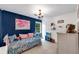 bedroom with blue accent wall, patterned bedding, and natural light from the window at 1209 Colony Cir, Marietta, GA 30068
