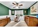 Bedroom with green walls, a ceiling fan, white wainscoting, and natural light from the window at 1209 Colony Cir, Marietta, GA 30068