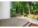 Back deck area offers a relaxing space with an outdoor dining area and wooded views at 1209 Colony Cir, Marietta, GA 30068