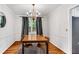 Bright dining room with hardwood floors, chandelier, and modern curtains at 1209 Colony Cir, Marietta, GA 30068