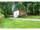 Well-manicured lawn and landscaping surround this traditional brick home with a two-car garage at 1209 Colony Cir, Marietta, GA 30068