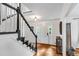 Light-filled foyer with hardwood floors, staircase, and white door with sidelights at 1209 Colony Cir, Marietta, GA 30068