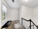 Well-lit hallway with a bench, large window, and staircase, offering a bright and airy feel at 1209 Colony Cir, Marietta, GA 30068